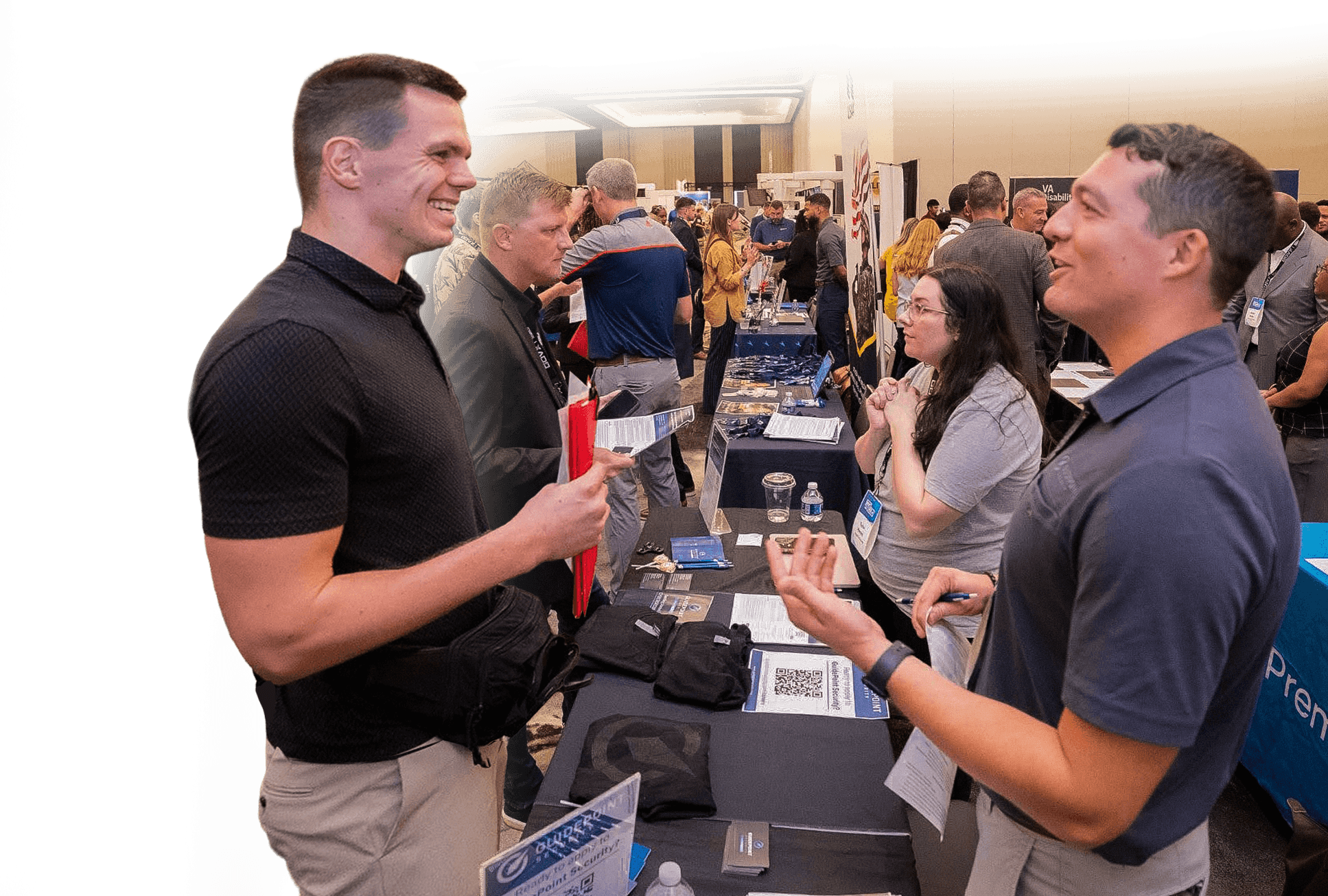 Attendees networking at a Marketplace booth during the Military Impact Conference